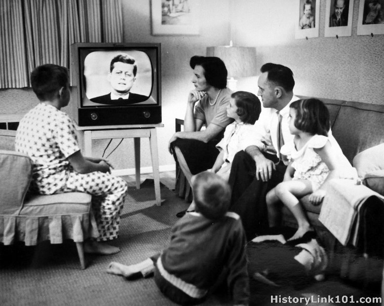A family watches a debate between John F. Kennedy and Richard Nixon